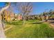 Expansive green lawn area with mature trees and building views at 900 S 94Th St # 1065, Chandler, AZ 85224