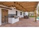 Outdoor kitchen and dining area under pergola at 12801 N 65Th Pl, Scottsdale, AZ 85254