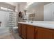 Bathroom featuring tile floors, vanity sink, framed mirror, bathtub, and decorative accents at 13524 W Sierra Vista Dr, Glendale, AZ 85307