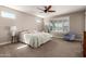 Bright bedroom with a ceiling fan, plantation shutters, and neutral decor at 13524 W Sierra Vista Dr, Glendale, AZ 85307