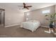 Spacious bedroom featuring neutral tones, carpet flooring, a ceiling fan, and natural light at 13524 W Sierra Vista Dr, Glendale, AZ 85307