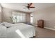 Bright bedroom with dual beds, a large window with shutter, and outdoor access at 13524 W Sierra Vista Dr, Glendale, AZ 85307