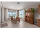 Bright dining room featuring a wooden table set, tile floors, and an antique hutch at 13524 W Sierra Vista Dr, Glendale, AZ 85307