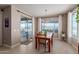 Bright dining room with tile floors and sliding glass doors leading to an outdoor patio at 13524 W Sierra Vista Dr, Glendale, AZ 85307