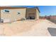 Backyard featuring a large garage and undeveloped desert landscaping at 13524 W Sierra Vista Dr, Glendale, AZ 85307