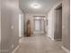Inviting hallway with tile flooring, neutral paint and bright lighting at 13524 W Sierra Vista Dr, Glendale, AZ 85307