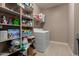 Functional laundry room with shelving, storage, a washer, and a dryer at 13524 W Sierra Vista Dr, Glendale, AZ 85307