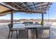 Outdoor kitchen and bar area featuring grill and seating, with a view of pool at 13524 W Sierra Vista Dr, Glendale, AZ 85307