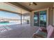 Outdoor patio with table, chairs, ceiling fan, and view of the beautiful pool at 13524 W Sierra Vista Dr, Glendale, AZ 85307