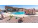 Outdoor pool with rock waterfall, desert landscaping, covered patio and an outdoor bar area at 13524 W Sierra Vista Dr, Glendale, AZ 85307