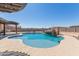 Backyard pool with a custom rock waterfall, mature desert landscaping and a covered patio at 13524 W Sierra Vista Dr, Glendale, AZ 85307