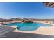 A backyard pool featuring a custom rock waterfall and mature desert landscaping at 13524 W Sierra Vista Dr, Glendale, AZ 85307