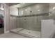 Modern tiled shower with glass enclosure, mosaic accent tile, and bench at 13524 W Sierra Vista Dr, Glendale, AZ 85307