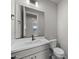 Clean bathroom with white vanity, toilet and a mirror at 2233 W Hide Trl, Phoenix, AZ 85085