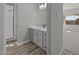 Modern bathroom with gray vanity, shower and wood-look flooring at 2233 W Hide Trl, Phoenix, AZ 85085