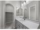 Elegant bathroom with a white vanity, large mirror, and walk-in closet at 2233 W Hide Trl, Phoenix, AZ 85085