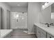 Elegant bathroom with gray double vanity and a large walk-in shower at 2233 W Hide Trl, Phoenix, AZ 85085