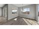 Bright dining room with large windows and a chandelier at 2233 W Hide Trl, Phoenix, AZ 85085