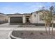 Front view of a single story home with dark brown garage door at 2233 W Hide Trl, Phoenix, AZ 85085