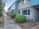 Charming exterior of a two-story building with blue and gray accents at 2608 W Berridge Ln # 220, Phoenix, AZ 85017