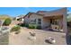 Relaxing backyard featuring a covered patio, desert landscaping, and mountain views at 27174 N 85Th Dr, Peoria, AZ 85383