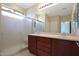 Bathroom with double sinks, vanity, and glass shower, providing a functional and modern space at 27174 N 85Th Dr, Peoria, AZ 85383