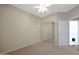 Bright bedroom with ceiling fan, carpeted floor, and closet, creating a cozy and functional space at 27174 N 85Th Dr, Peoria, AZ 85383