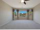 Bedroom features a large window with curtains and carpeting throughout at 27174 N 85Th Dr, Peoria, AZ 85383