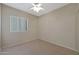 A cozy bedroom featuring neutral walls, carpet flooring, and a ceiling fan for added comfort at 27174 N 85Th Dr, Peoria, AZ 85383