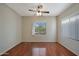 A naturally lit bedroom with hardwood floors and a window view of the desert landscape at 27174 N 85Th Dr, Peoria, AZ 85383