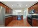 Well-lit kitchen boasts wood floors, dark wood cabinets, and stainless steel appliances at 27174 N 85Th Dr, Peoria, AZ 85383