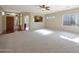 Open-concept living room features carpet, hardwood floors, and abundant natural light at 27174 N 85Th Dr, Peoria, AZ 85383