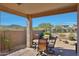 Covered patio with brick pavers overlooking desert landscaping at 27174 N 85Th Dr, Peoria, AZ 85383