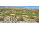 Aerial view of golf course with sand traps and lush greenery; mountain range backdrop at 3576 N Carlton St, Buckeye, AZ 85396
