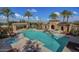 Resort-style pool and jacuzzi with palm trees, perfect for relaxation and entertainment at 3576 N Carlton St, Buckeye, AZ 85396
