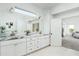 Bathroom with marble countertops, double sinks and access to bedroom at 10413 N 118Th Pl, Scottsdale, AZ 85259