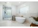 Spa-like bathroom with freestanding tub and glass-enclosed shower at 10413 N 118Th Pl, Scottsdale, AZ 85259