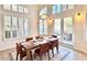 Bright dining room with wood table, six chairs, and access to backyard at 10413 N 118Th Pl, Scottsdale, AZ 85259