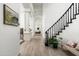 Bright hallway with wood floors and a staircase at 10413 N 118Th Pl, Scottsdale, AZ 85259