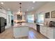 Modern kitchen with white cabinets, large island, and stainless steel appliances at 10413 N 118Th Pl, Scottsdale, AZ 85259