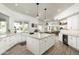 Spacious kitchen featuring white cabinets and a large island at 10413 N 118Th Pl, Scottsdale, AZ 85259