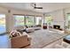 Living room features a fireplace, large windows, and access to backyard at 10413 N 118Th Pl, Scottsdale, AZ 85259