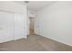 Bedroom featuring a large closet with sliding doors and neutral carpet at 16038 W Desert Hollow Dr, Surprise, AZ 85387