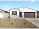 Charming single-story home with a two-car garage and low-maintenance desert landscaping at 16038 W Desert Hollow Dr, Surprise, AZ 85387