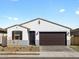 Beautiful single-story home with neutral colors, a two-car garage, and desert landscaping at 16038 W Desert Hollow Dr, Surprise, AZ 85387