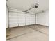 Spacious garage with concrete floors and white garage door at 16038 W Desert Hollow Dr, Surprise, AZ 85387