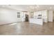 Open floorplan with kitchen, dining, and living areas featuring tile floors and modern lighting at 16038 W Desert Hollow Dr, Surprise, AZ 85387