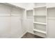 A walk-in closet features built-in shelving for organization at 16038 W Desert Hollow Dr, Surprise, AZ 85387