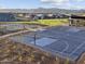 A community park basketball court featuring hoops with mountain views and new construction homes in the background at 17672 W Pierson St, Goodyear, AZ 85395