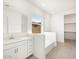 Primary bathroom with soaking tub, double vanity and walk-in closet at 17672 W Pierson St, Goodyear, AZ 85395